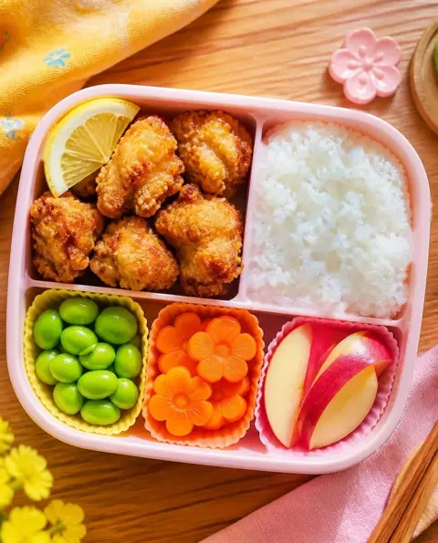 Overhead photo of Baked Karaage-Style Chicken Bites packed in a colourful kids' lunchbox