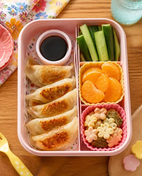 Overhead photo of Mini Pan-Fried Gyoza packed in a colourful kids' lunchbox